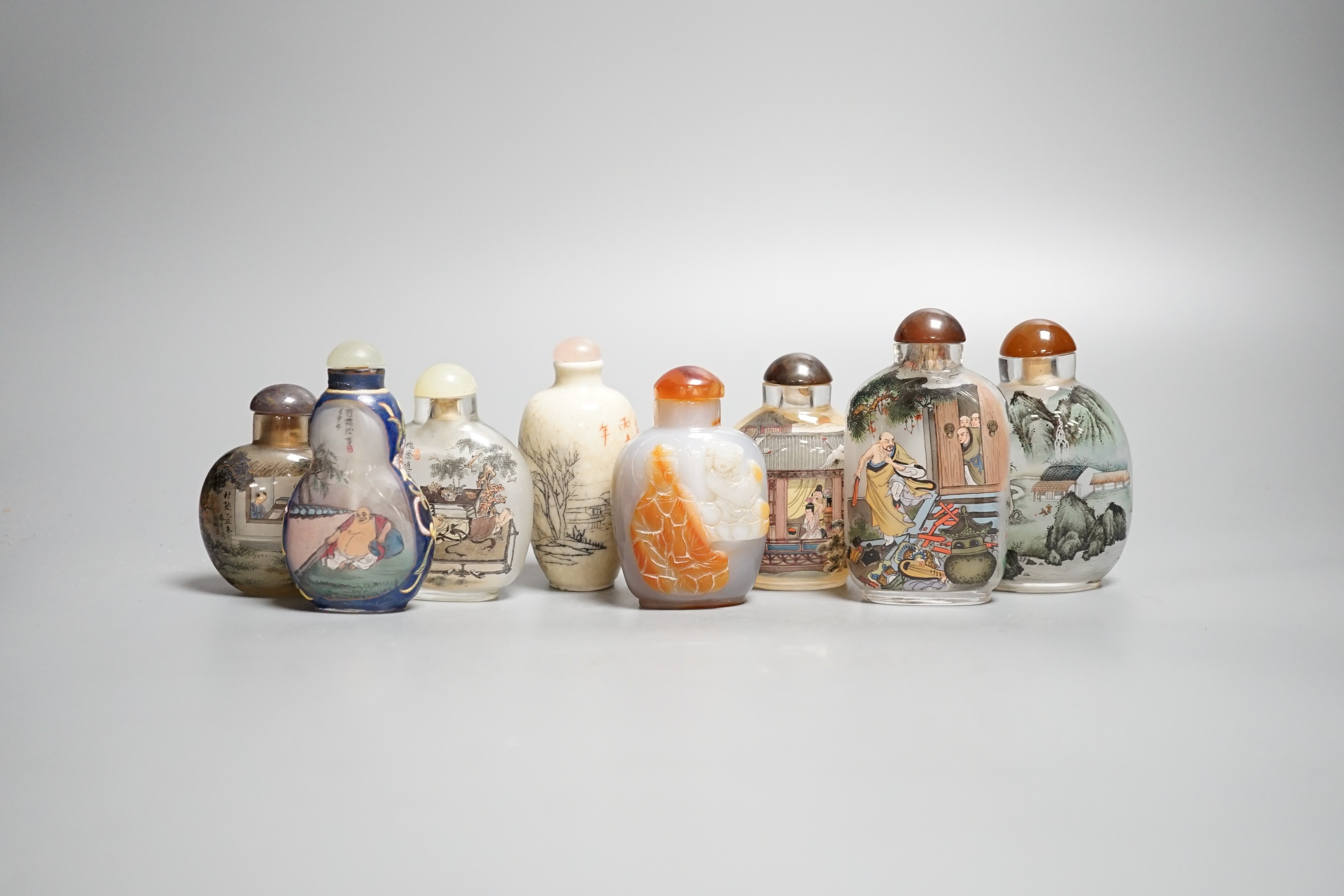 Six Chinese inside painted glass snuff bottles, an agate cameo snuff bottle and an incised crackle glaze snuff bottle, tallest 9cm